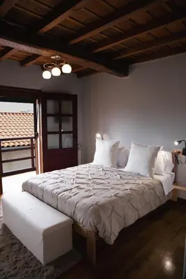 a bedroom with a large bed with white pillows at Casa Trillo en centro de Monforte de Lemos in Monforte de Lemos
