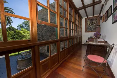a room with large windows and a chair and a table at Pazo da Trave in Viveiro