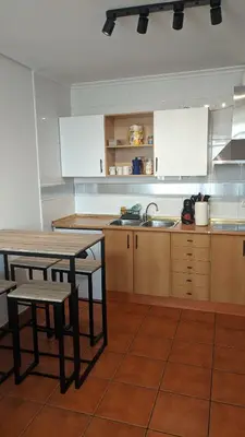 a kitchen with a table and chairs and a sink at Refugio de mar in Barreiros