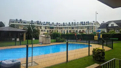 a swimming pool in front of a large building at Refugio de mar in Barreiros