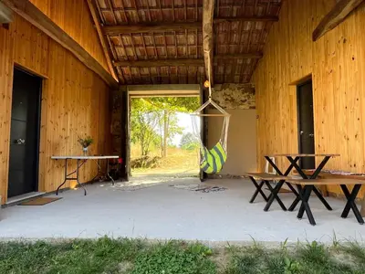 a patio with a bench and a hammock in a building at Bella Casa Araujo in Lamas