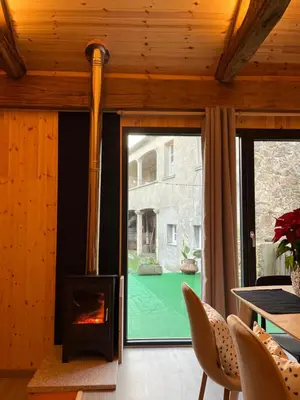 a fireplace in a living room with a table and chairs at Bella Casa Araujo in Lamas