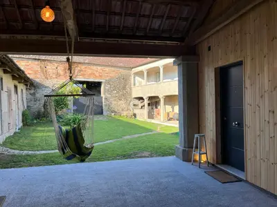 a porch with a hammock hanging from a building at Bella Casa Araujo in Lamas