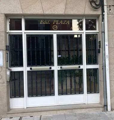 a store front with glass doors in a building at Apartamento entero Frama Caldas in Caldas de Reis
