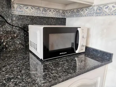a microwave sitting on a counter in a kitchen at Apartamento entero Frama Caldas in Caldas de Reis