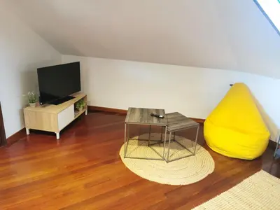 a living room with a table and a yellow couch at Apartamento entero Frama Caldas in Caldas de Reis