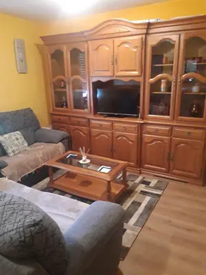 a living room with couches and a entertainment center at Casa Lavandeira in Ourense