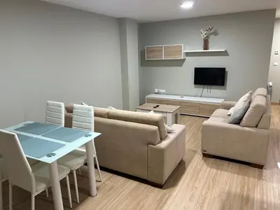 a living room with a couch and a table at Piso de diseño in Verín