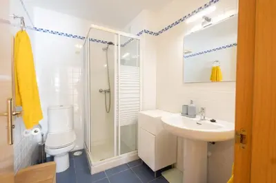 a bathroom with a toilet and a sink and a shower at Casa Miño Golf in Miño