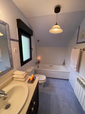 a bathroom with a tub and a sink and a toilet at Los Diales in Cangas del Narcea