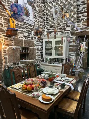 a wooden table with food on it in a kitchen at O Forno de Catuxa Cottage & Roman Wall in Lugo