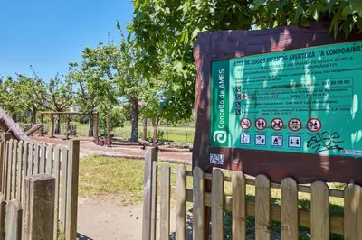 a sign in a park next to a fence at Casa Condomiña in Amés