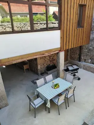 a table and chairs on a patio with a table at Casa Rural Xures Lobios in Ourense