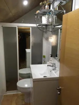 a bathroom with a sink and a toilet and a mirror at Casa Pataco in Cangas del Narcea