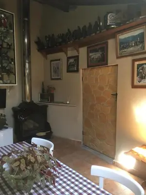 a room with a table and a door with a fireplace at Casa Pataco in Cangas del Narcea