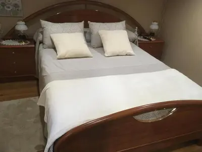a bedroom with a large bed with white sheets and pillows at Casa Pataco in Cangas del Narcea
