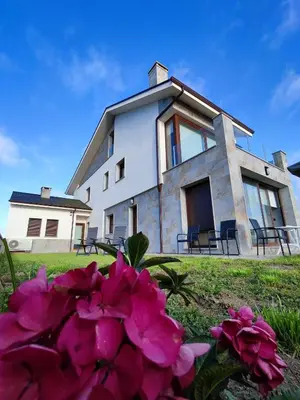 a house with pink flowers in front of it at Villa Quelle in Sieiro