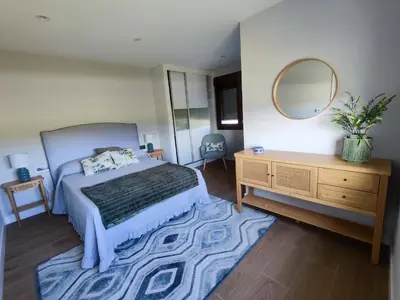 a bedroom with a bed and a dresser and a mirror at Villa Quelle in Sieiro