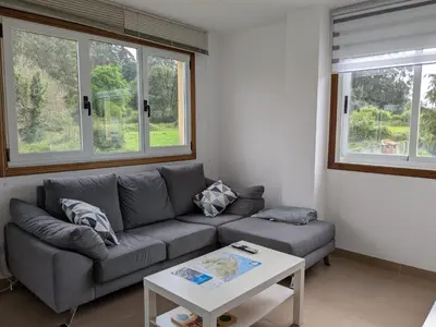 a living room with a couch and a table at Playa de Miño in Miño