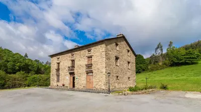an old stone building sitting in a field at Finca O Bizarro in Trabada