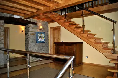 a staircase in a house with a stone wall at Finca O Bizarro in Trabada