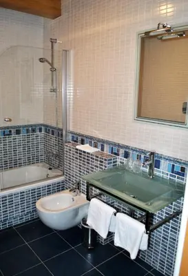 a bathroom with a tub and a sink and a bath tub at Finca O Bizarro in Trabada