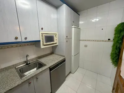 a small kitchen with a sink and a microwave at Bierzo Explore in Ponferrada
