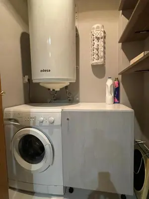 a washer and dryer with a cabinet on top of it at Bierzo Explore in Ponferrada