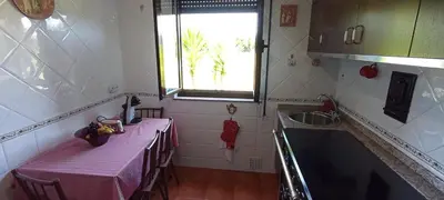 a kitchen with two tables and a sink and a window at EnSan CIPRIAN Casa Lula in Cervo