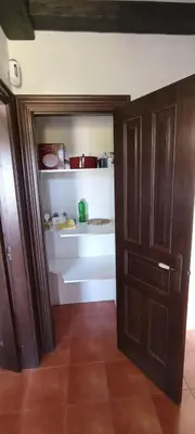 a room with a door and a kitchen with some pots and pans at EnSan CIPRIAN Casa Lula in Cervo