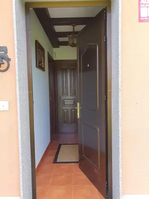 an open door into a hallway with a rug at EnSan CIPRIAN Casa Lula in Cervo