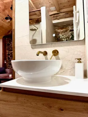 a bathroom with a white sink and a mirror at CASA BORAL- Comfort exclusivo en plena naturaleza - Valle del Silencio in Manzanedo de Valdueza