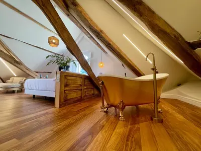a woman in a bath tub with a glass of wine at Villa Boutique 1880 -Romantic Historic Villa & Private Outdoor Spa- Adults Only in A Lama