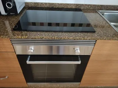 a stainless steel dishwasher in a kitchen next to a sink at Melide Suites By OL in Melide