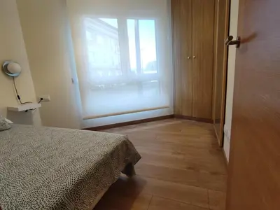 a bedroom with a bed and a large window at Melide Suites By OL in Melide