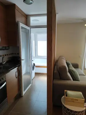 a kitchen and a living room with a couch at Melide Suites By OL in Melide