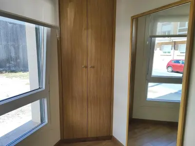 a room with a wooden cabinet and a window at Melide Suites By OL in Melide