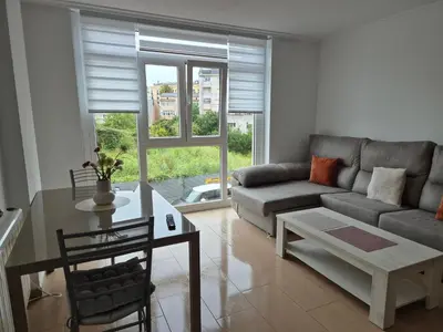 a living room with a couch and a table at Apartamento céntrico, tranquilo, buenas vistas in Ribadeo