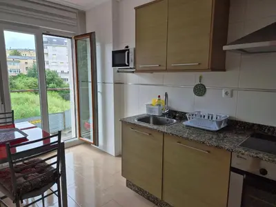 a kitchen with a sink and a counter top at Apartamento céntrico, tranquilo, buenas vistas in Ribadeo