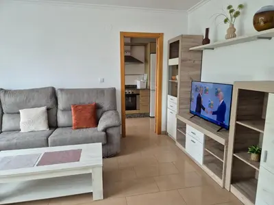 a living room with a couch and a flat screen tv at Apartamento céntrico, tranquilo, buenas vistas in Ribadeo
