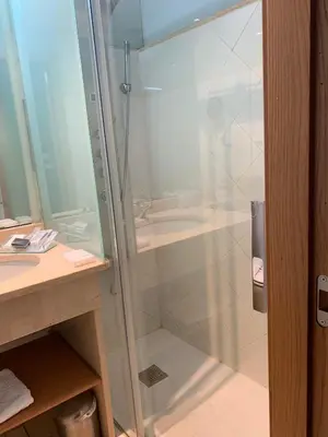 a glass shower in a bathroom with a sink at Posada Real La Carteria in Puebla de Sanabria
