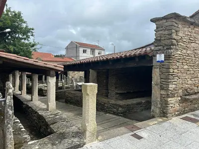 an old stone building with a stone bridge at Casa Agolada in Golada