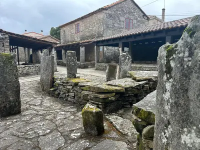a group of stone barriers in front of a building at Casa Agolada in Golada