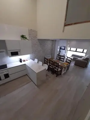 a staircase in a house with a table and chairs at La Herencia A VuT 1229 in Ponferrada