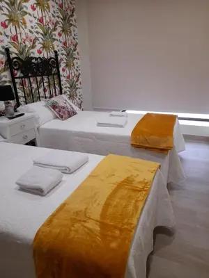 a kitchen and living room with a table and chairs at La Herencia A VuT 1229 in Ponferrada