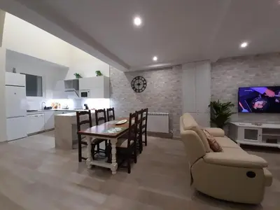 a living room with a couch and a tv at La Herencia A VuT 1229 in Ponferrada