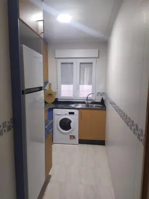 a kitchen with a washing machine and a sink at Almar in Ribadeo