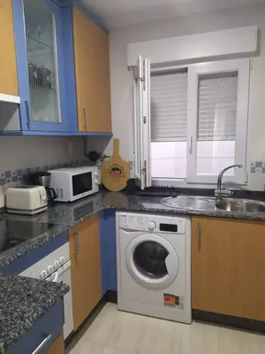a kitchen with a washing machine and a sink at Almar in Ribadeo