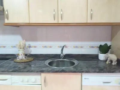 a kitchen counter top with a sink and a counter top at Apartamento Ziralla- con Garaje Gratis in Allariz