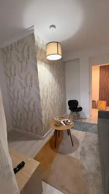 a living room with a table and a chair at La casa de Elena con terraza en el centro in Lugo